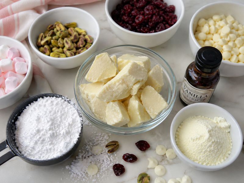 Ingredients for homemade white chocolate recipe arranged on a kitchen counter.