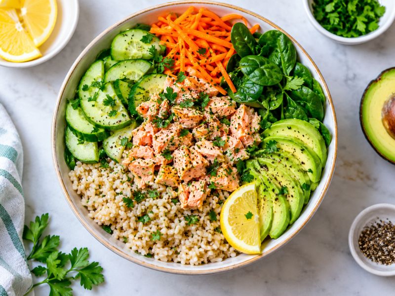 lemon herb canned salmon rice bowl with vegetables and avocado